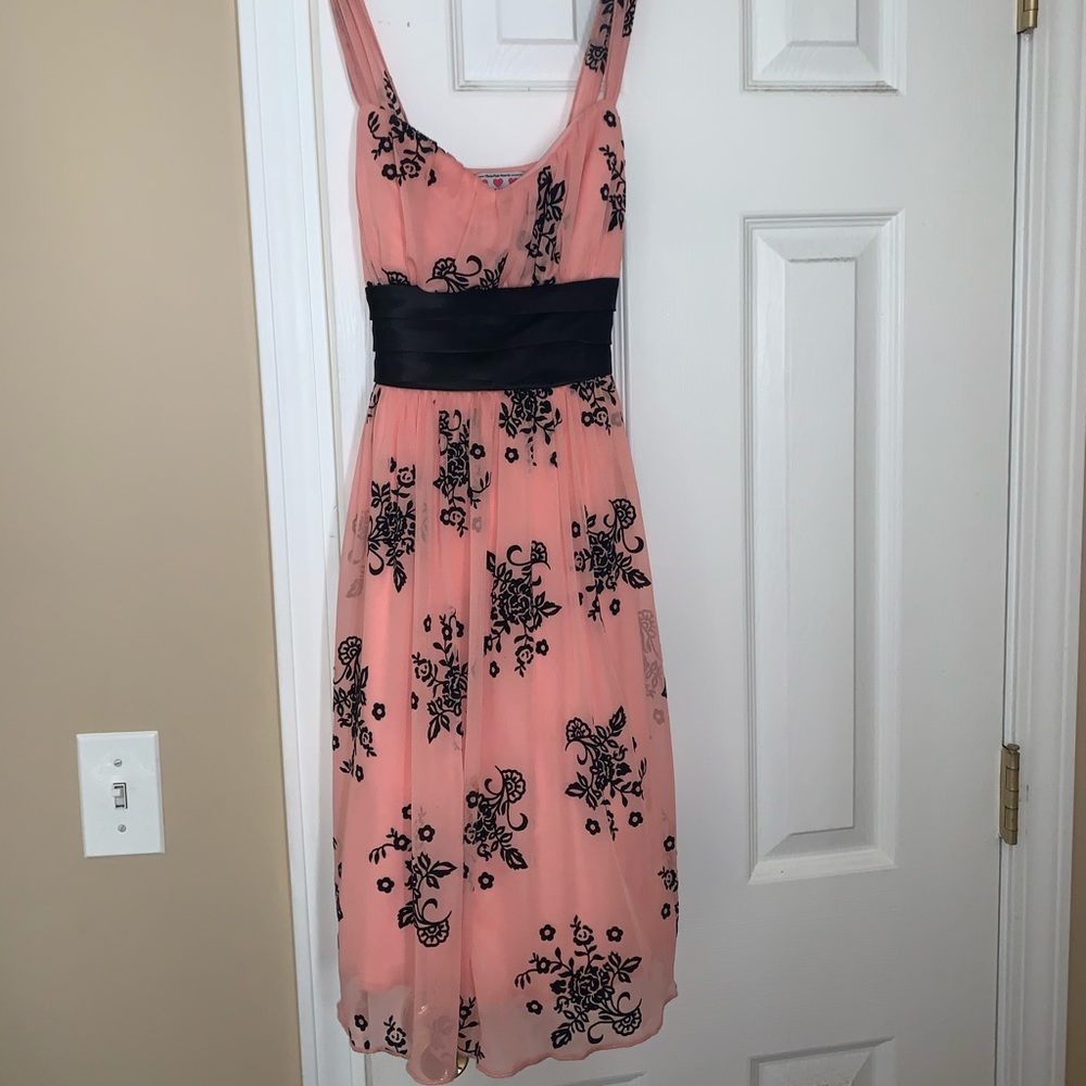 Pink dress with black flowered design.